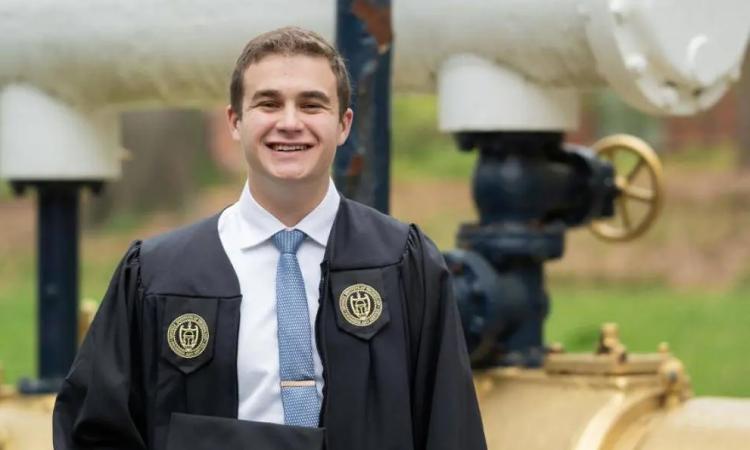 Owen Pittman poses in his graduation cap and gown.